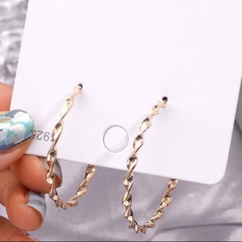 Gold and silver plated spiral circle earrings.